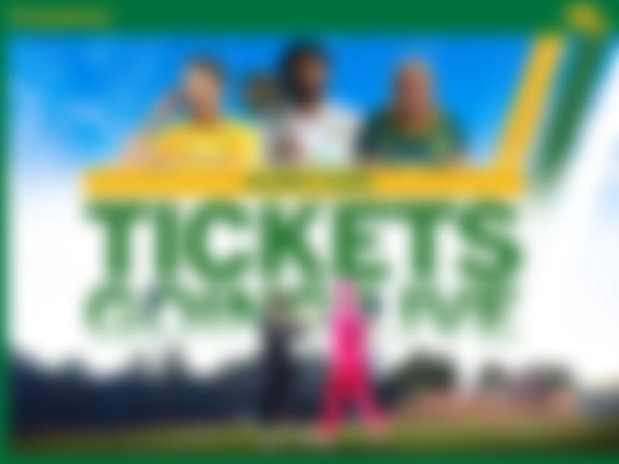 Blurry group photo of people on a stage with a blue sky backdrop.